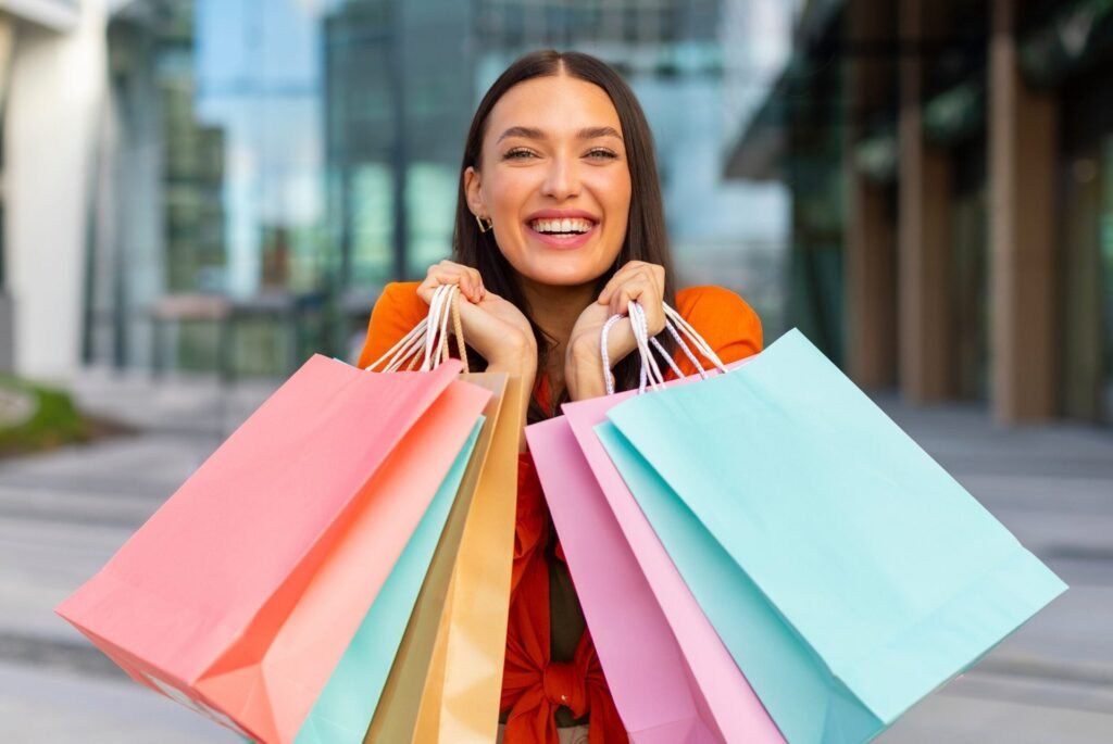Happy female shopper with shopping bags