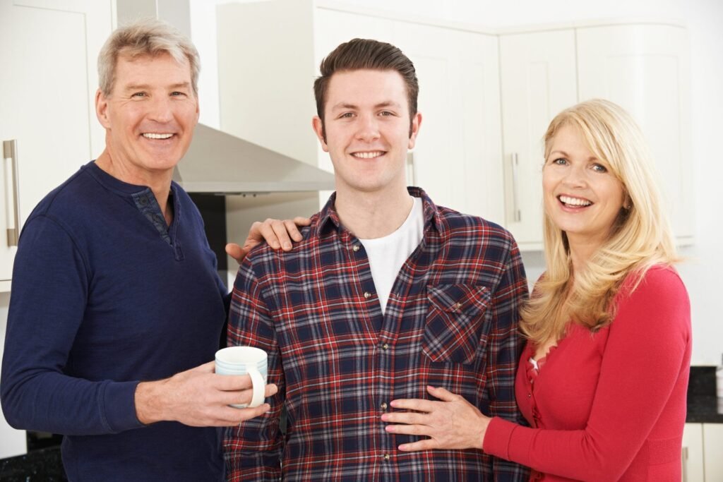 Before You Leave House to Your Kids, Consider These Pros and Cons Happy parents with their adult son