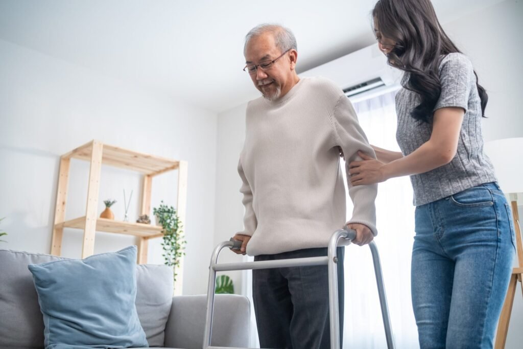 11 Ways to Pay for Long-Term Care Without Buying Expensive Insurance Young woman helps her senior father with his walker at home.
