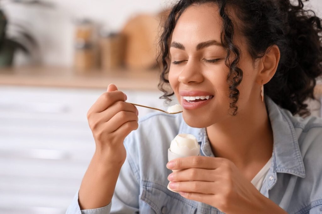 Woman eating a boiled egg
