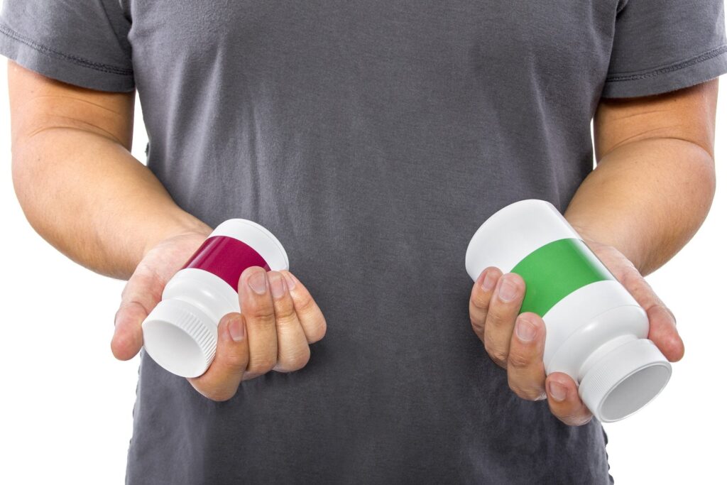 Man comparing generic and name brand pills or vitamins