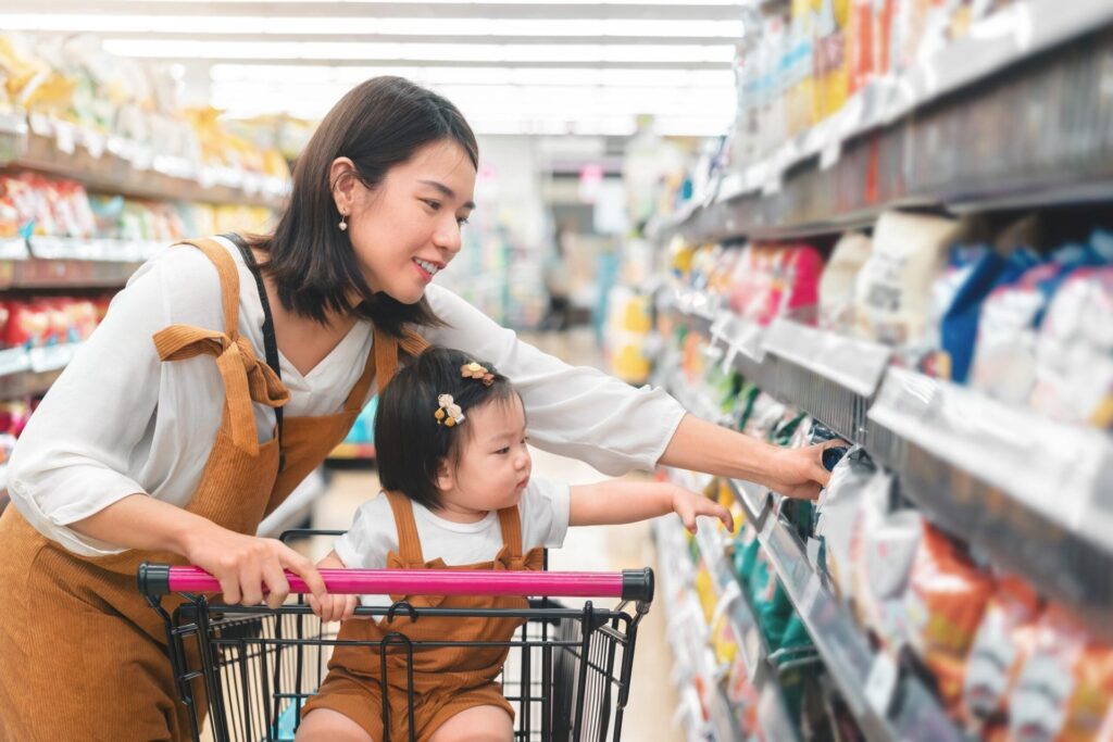 Mom and toddler shopping for groceries
