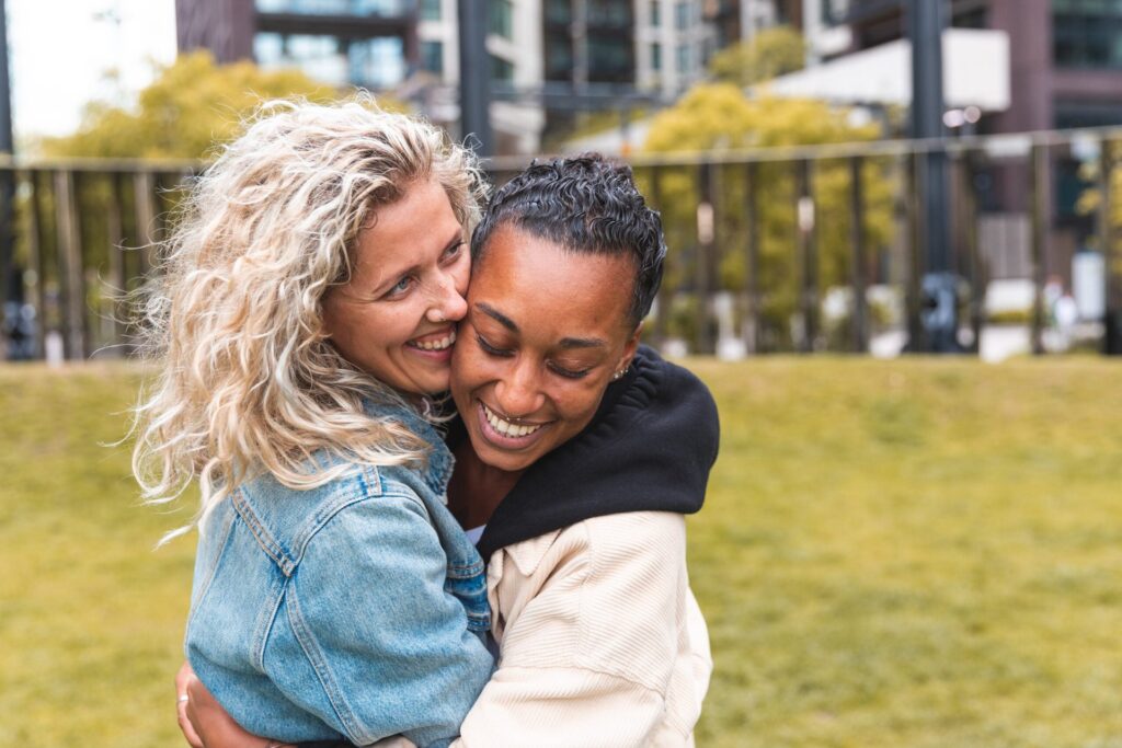 Couple laughing and hugging at a park