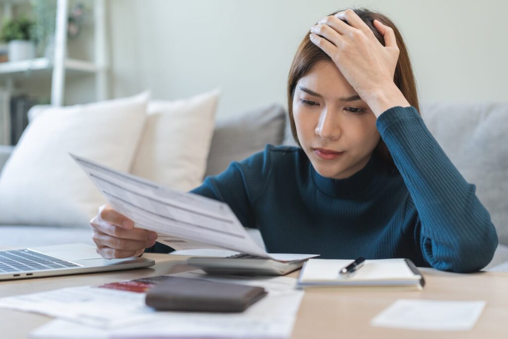 Young woman stressed and confused about income and taxes