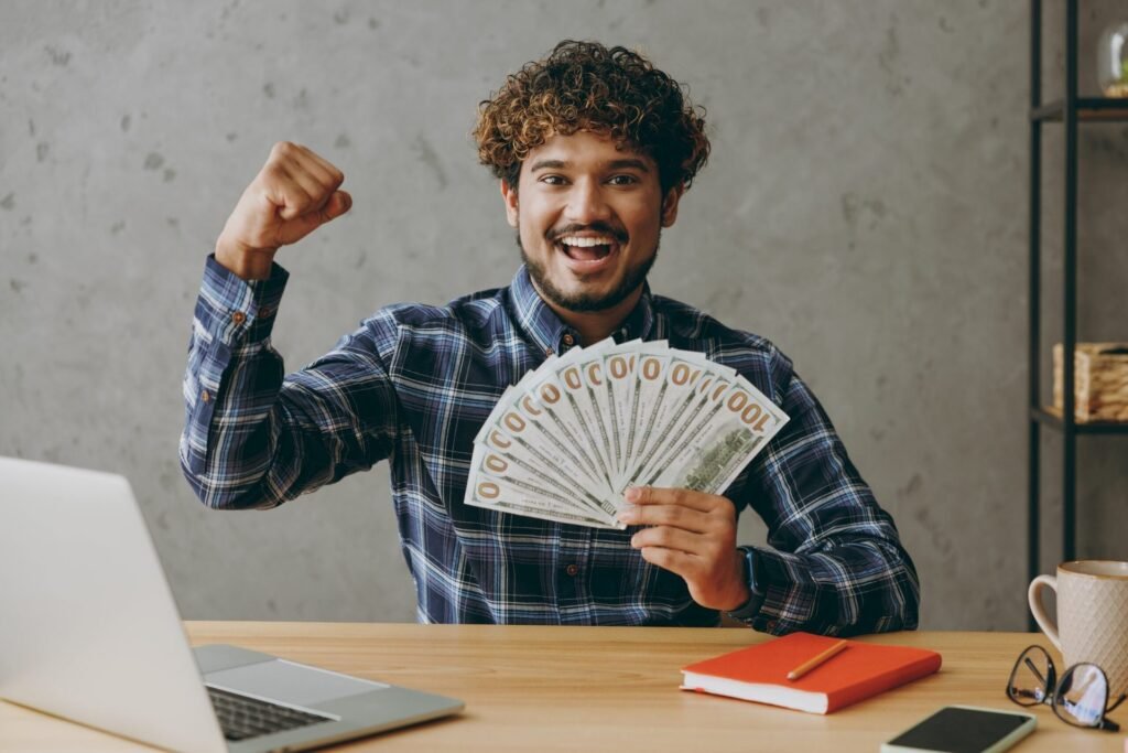 Young man smiling and holding money
