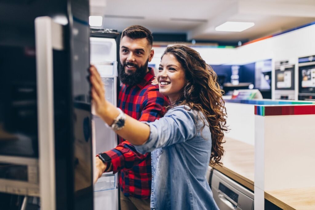 How to Time Your Purchases to Save Money Every Single Month Couple shopping for a refrigerator