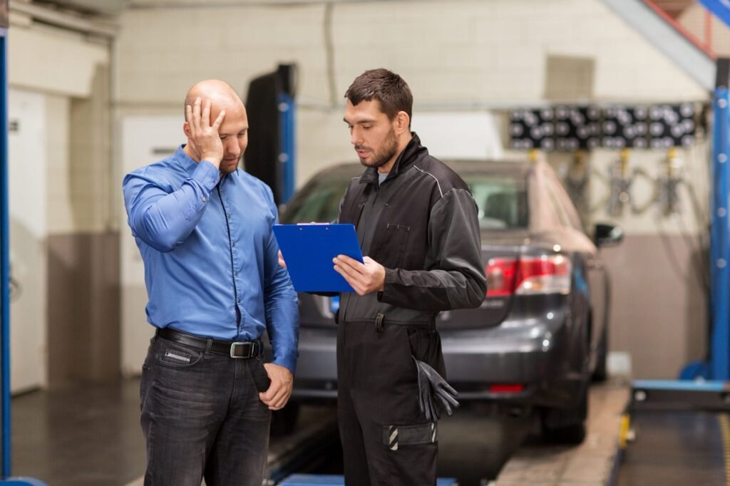 Is Your Mechanic Lying to You? 7 Red Flags That You’re Being Ripped Off Man worried with a mechanic