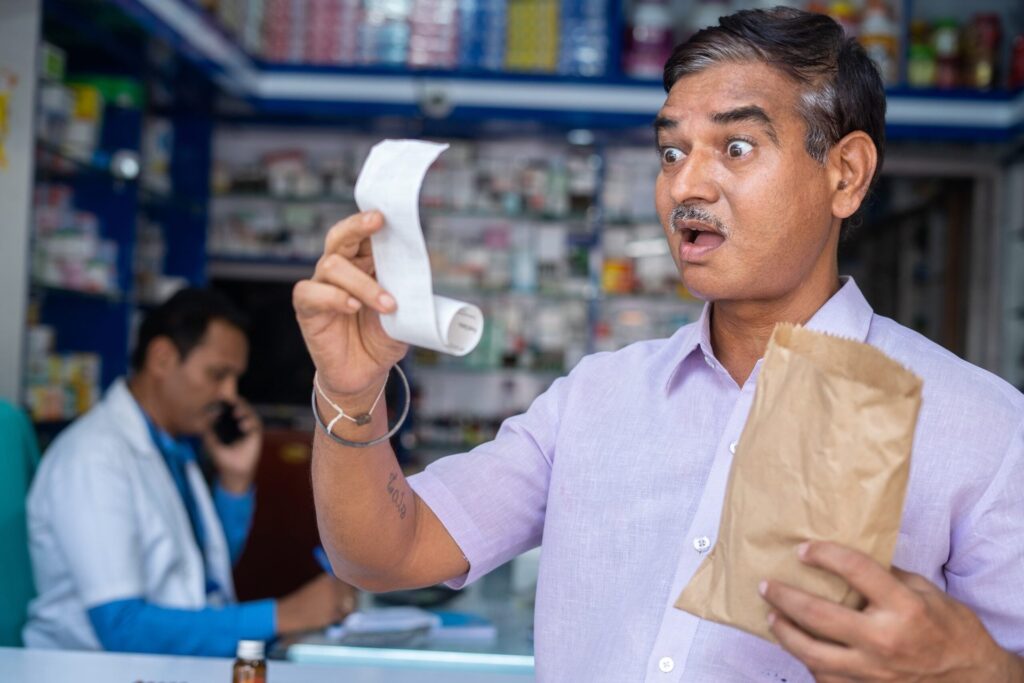 Older man at the pharmacy shocked by prescription price