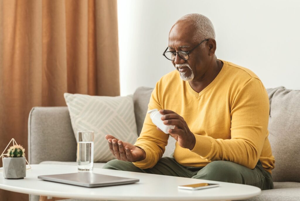 Older man taking a medication
