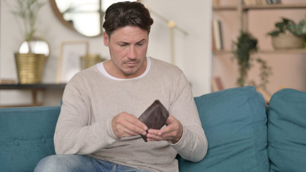 Middle-aged man with empty wallet