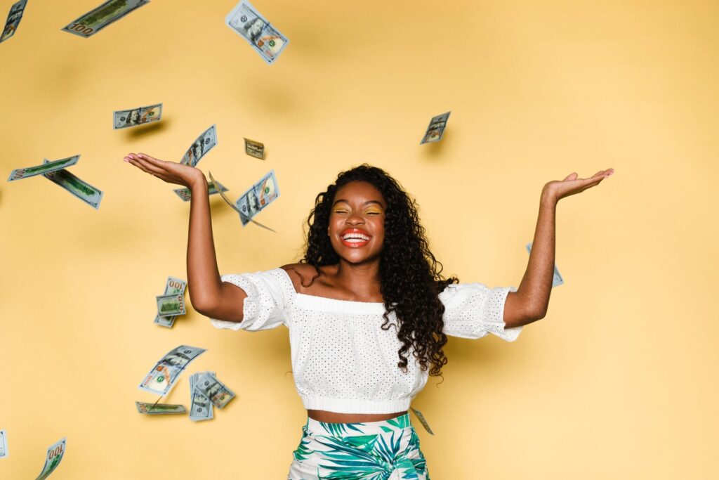 The February Fiscal Fast: 4 Simple Steps to Save $500 During the Shortest Month of the Year Cash raining down on an excited, smiling woman