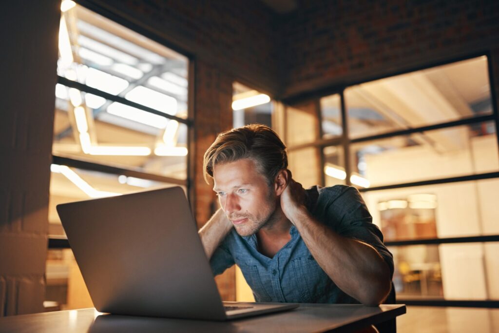 Man concentrating while working on a laptop