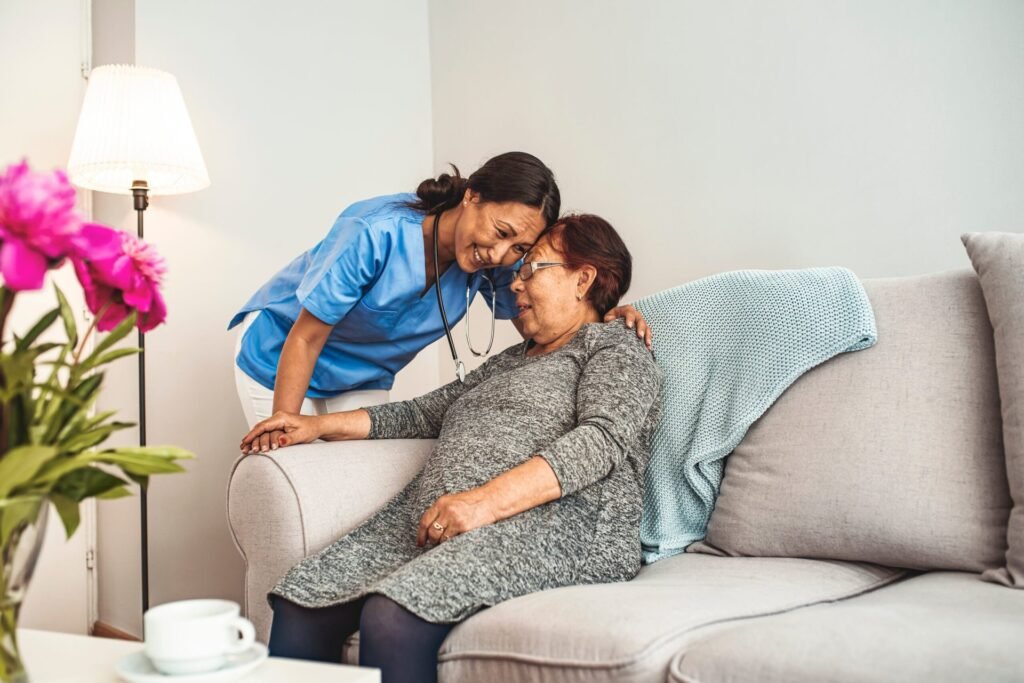 Nurse or caregiver hugging an older patient with in-home care.