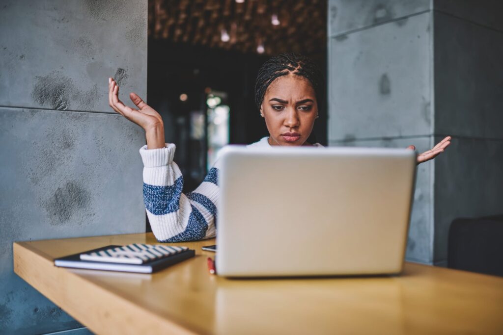 woman confused looking at laptop