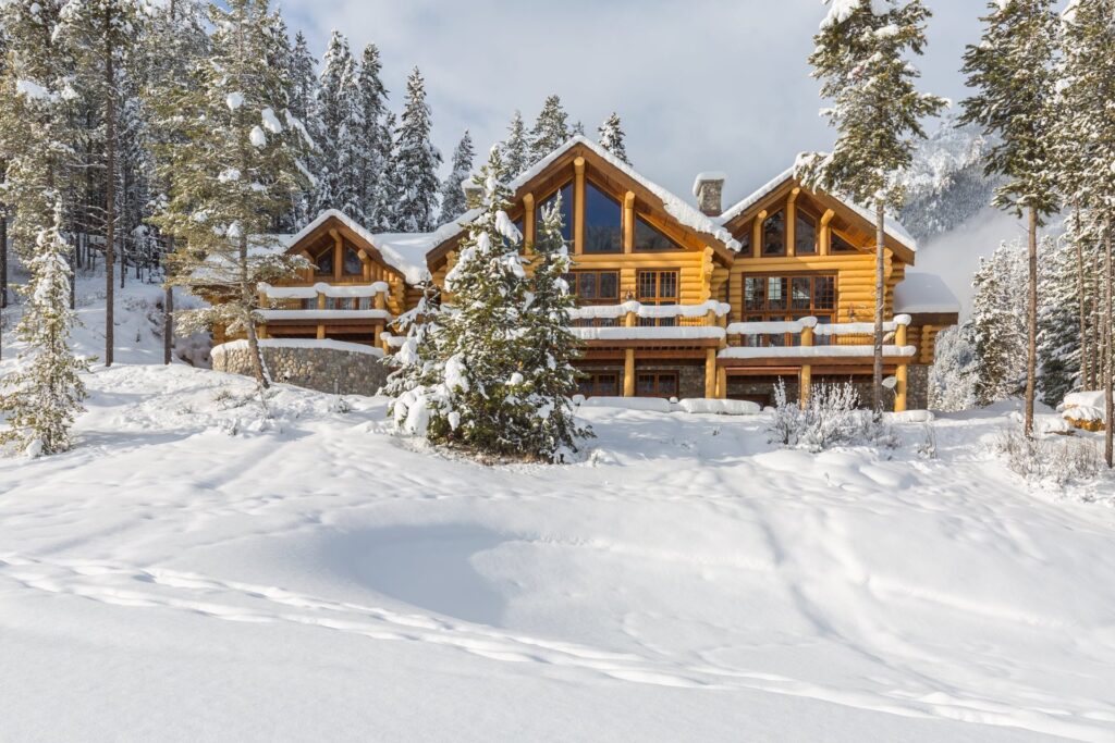 A log cabin home after a snowfall