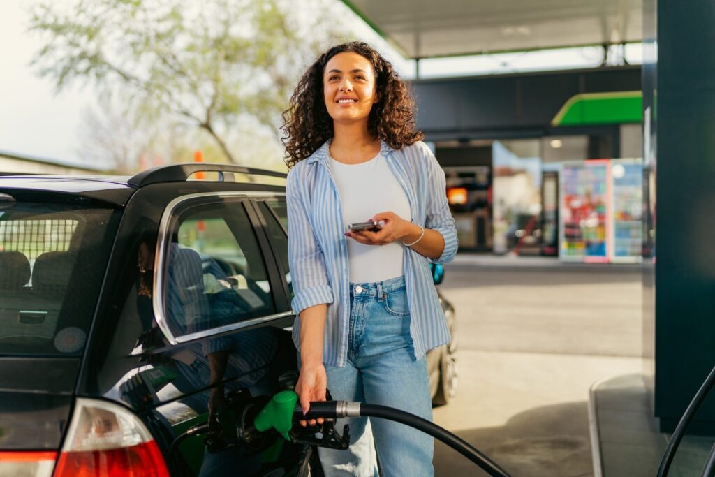 Woman pumping gas