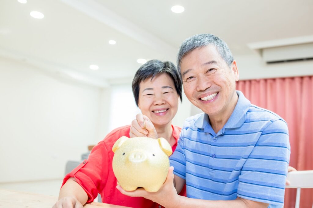 Here’s Where to Put Your Next Retirement Dollar for Maximum Growth Older couple with a piggy bank