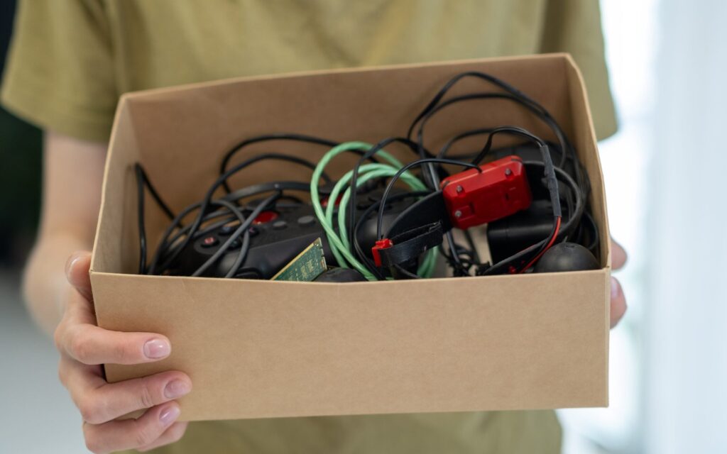 Person holding box of old cords