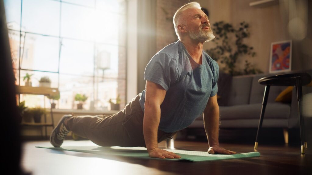 A senior man does yoga.